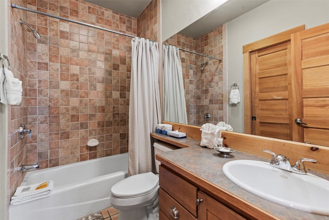 12 Big Boulder Court, Unit 13 Keystone, CO 80435 - Photo 27 of 35 a bathroom with a granite countertop sink toilet and shower