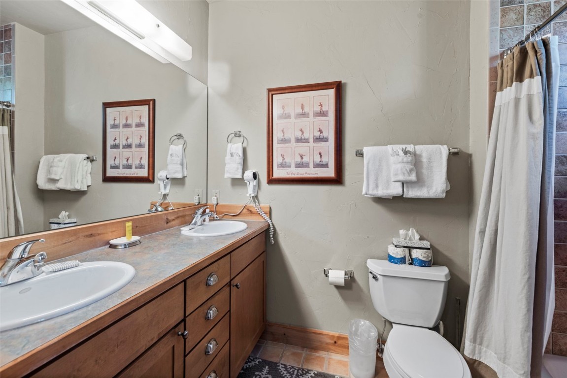 12 Big Boulder Court, Unit 13 Keystone, CO 80435 - Photo 32 of 35 a bathroom with a toilet sink and mirror