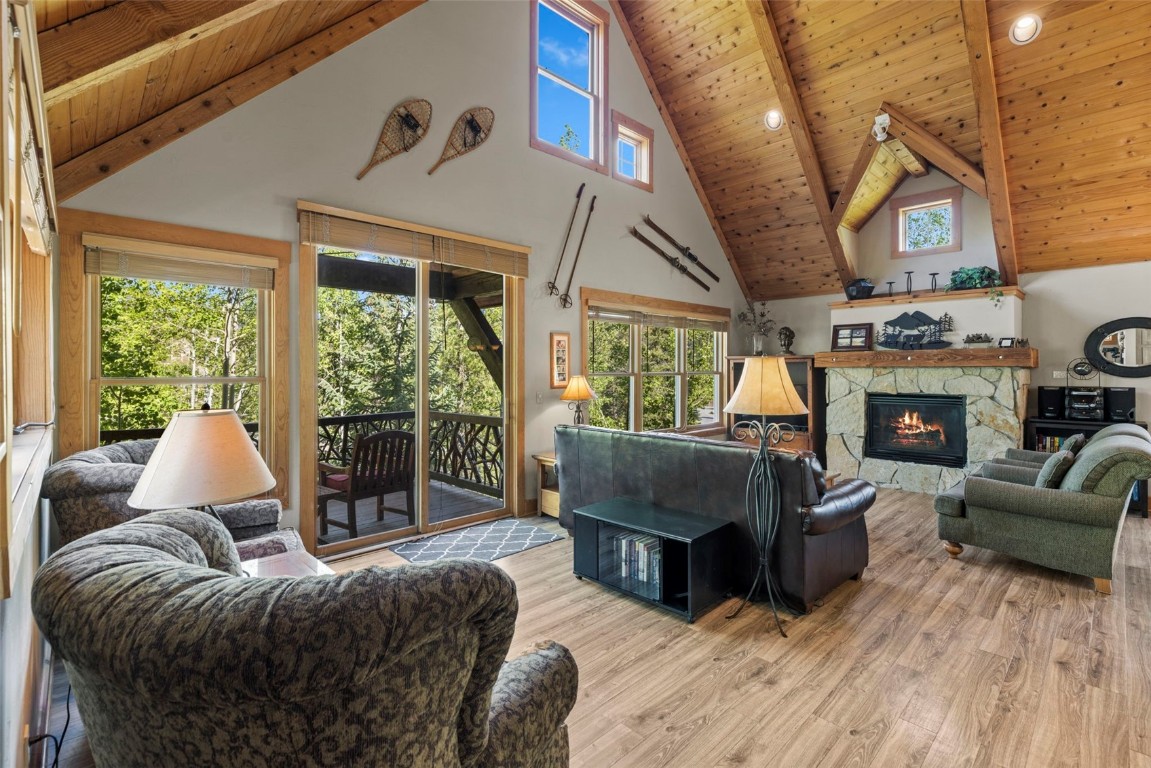 12 Big Boulder Court, Unit 13 Keystone, CO 80435 - Photo 5 of 35 a living room with furniture a fireplace and a floor to ceiling window