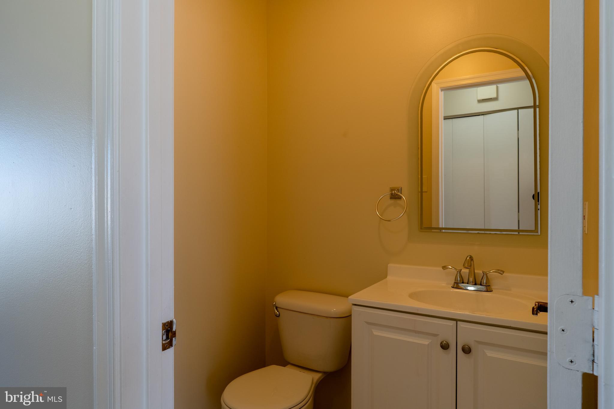 224 Oak Leaf Way Halethorpe, MD 21227 - Photo 12 of 32 a bathroom with a toilet sink vanity and mirror