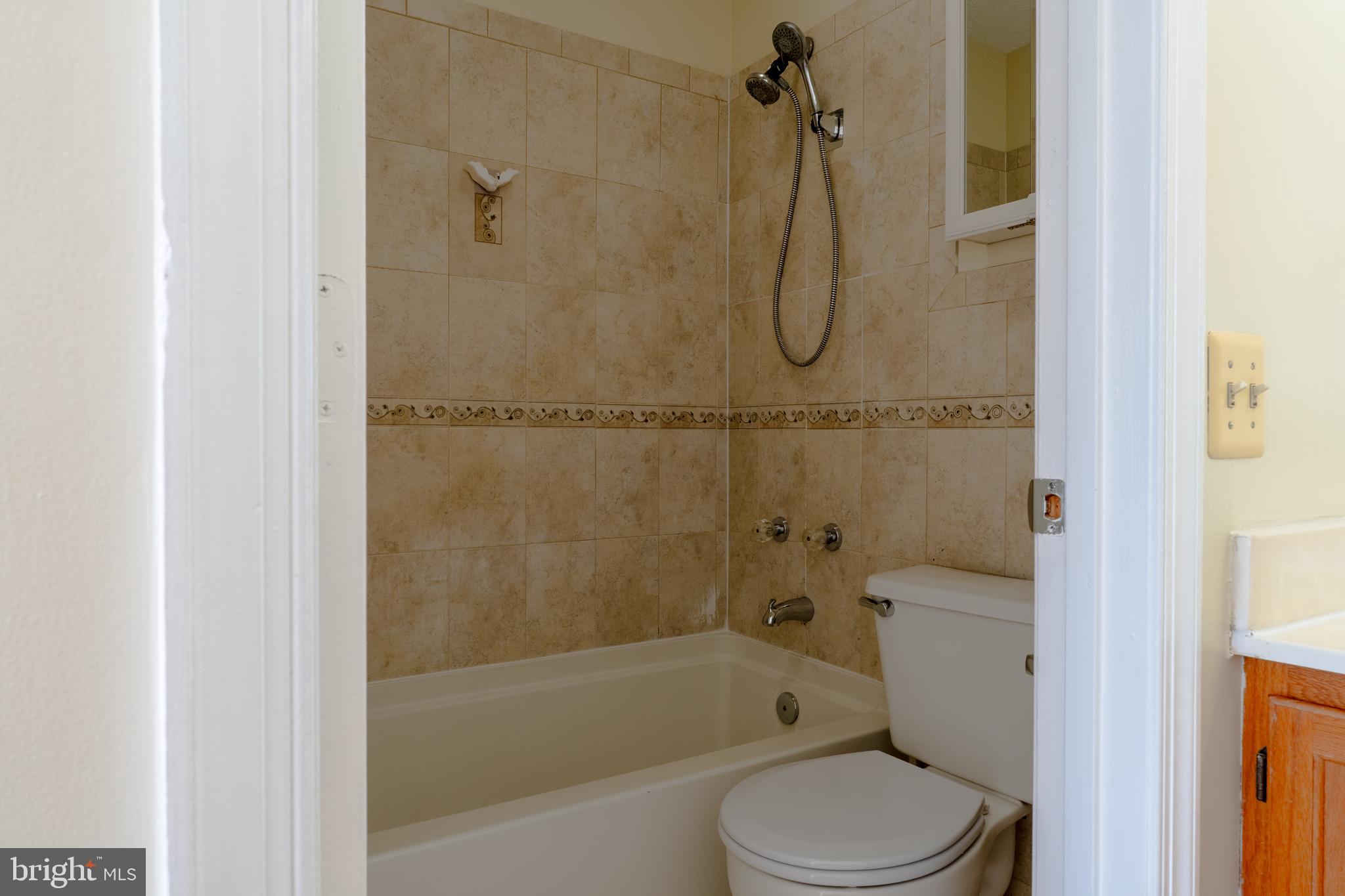 224 Oak Leaf Way Halethorpe, MD 21227 - Photo 17 of 32 a bathroom with a granite countertop toilet sink and shower