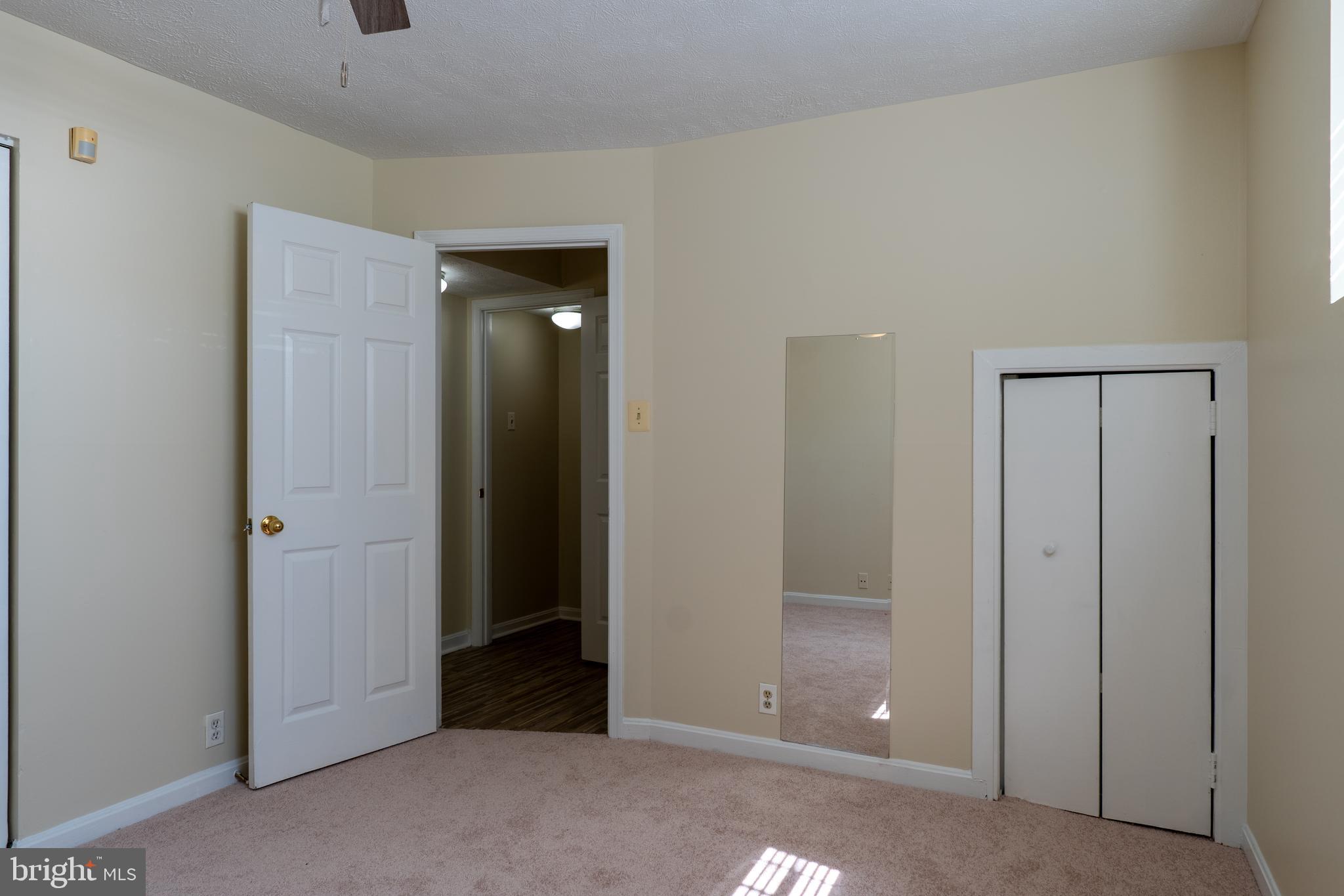 224 Oak Leaf Way Halethorpe, MD 21227 - Photo 26 of 32 a view of an empty room with closet and wooden door