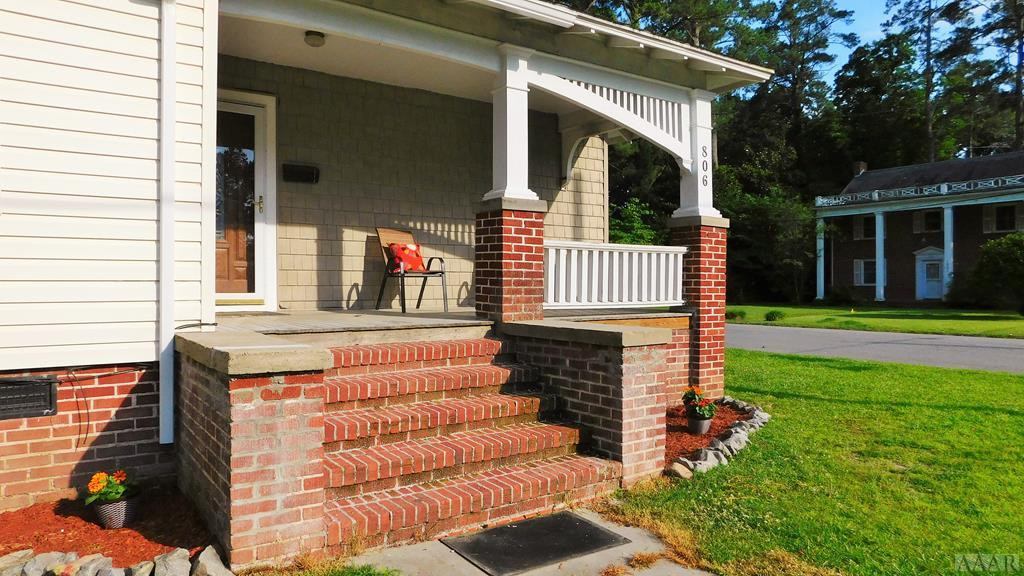 806 Raleigh Street Elizabeth City, NC 27909 - Photo 2 of 23 New landscaping with chairs on the porch and a nic