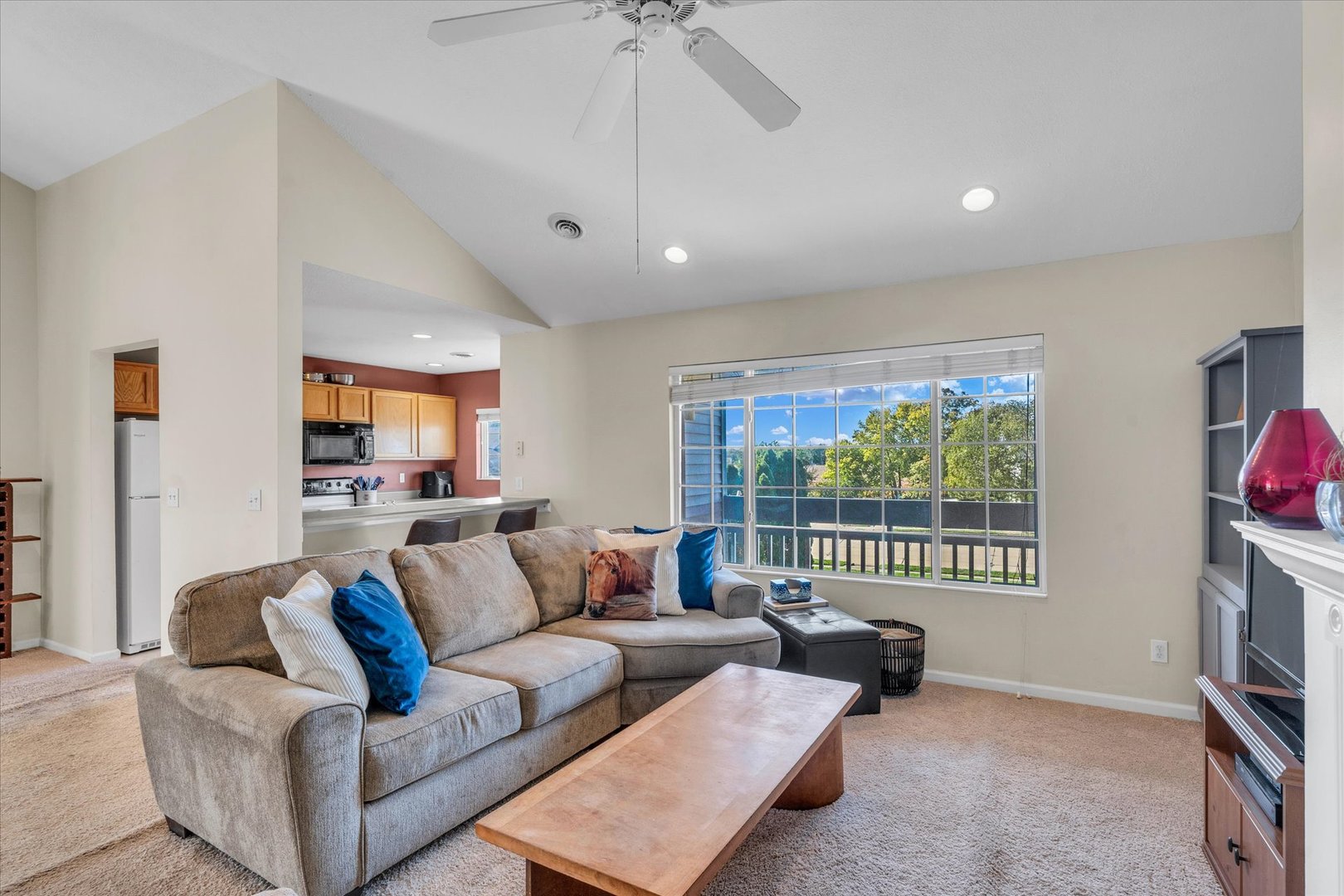 2402 Windward Boulevard, Unit 210 Champaign, IL 61821 - Photo 12 of 28 a living room with furniture and a flat screen tv