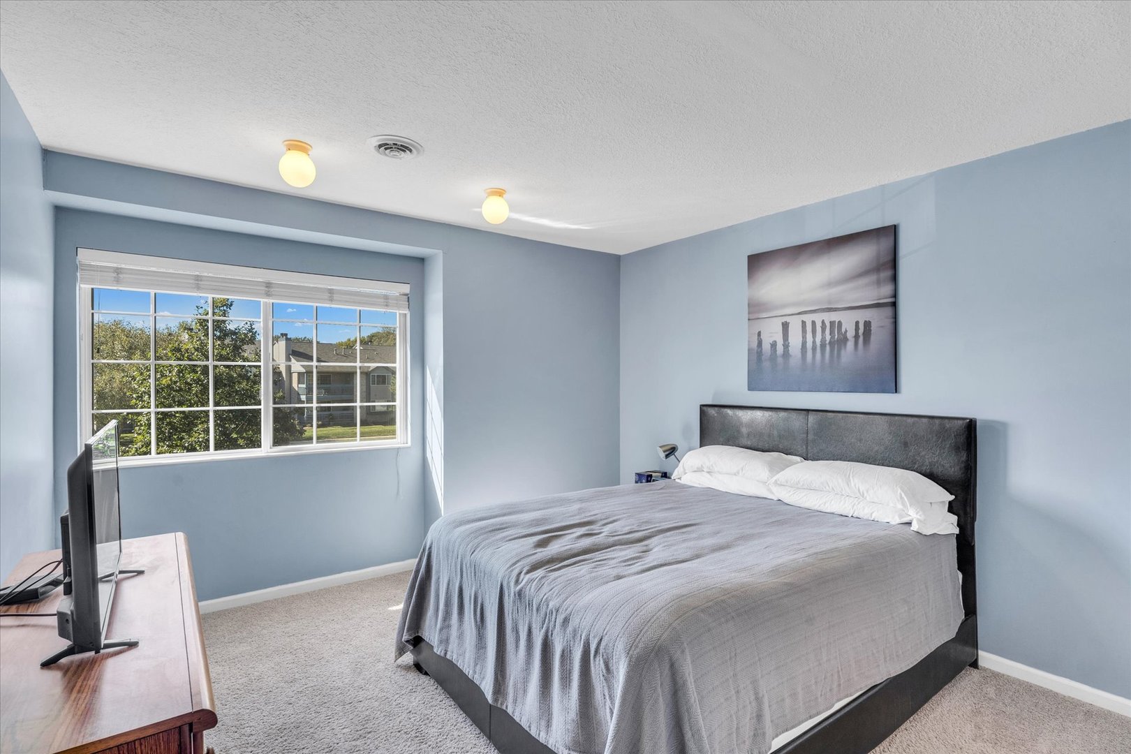 2402 Windward Boulevard, Unit 210 Champaign, IL 61821 - Photo 17 of 28 a bedroom with a bed and a window