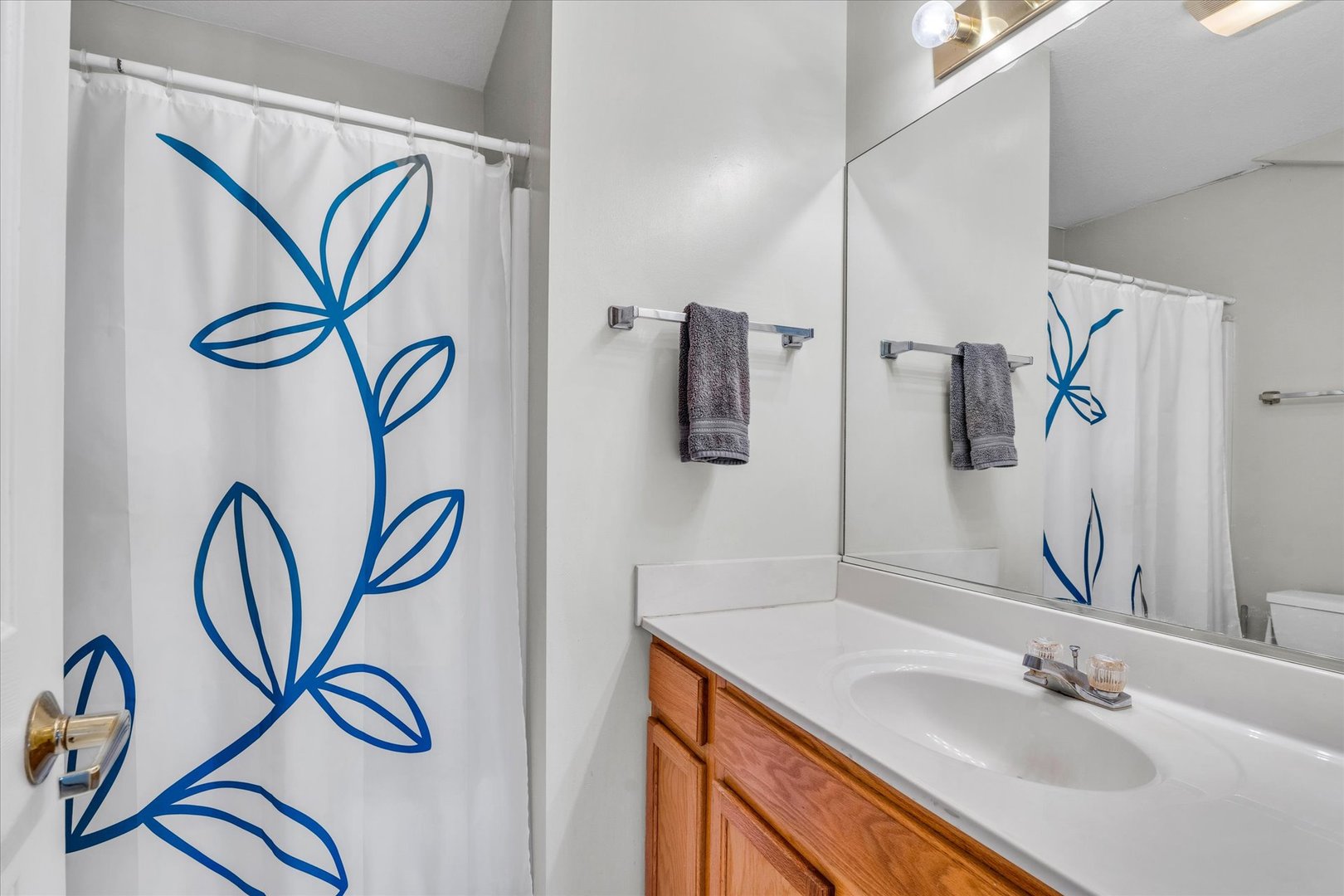2402 Windward Boulevard, Unit 210 Champaign, IL 61821 - Photo 20 of 28 a bathroom with a sink and a mirror