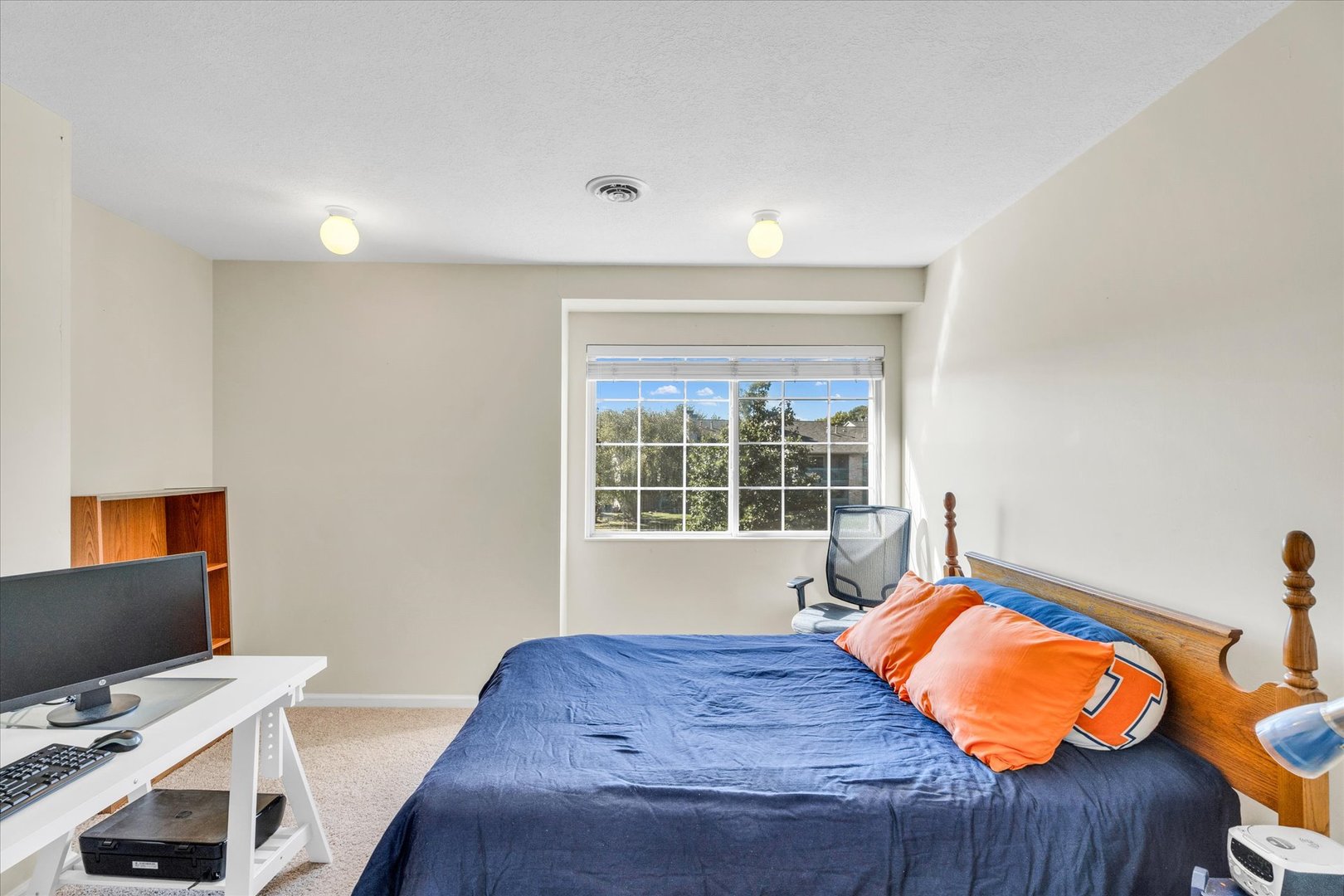 2402 Windward Boulevard, Unit 210 Champaign, IL 61821 - Photo 21 of 28 a bedroom with a bed and a window