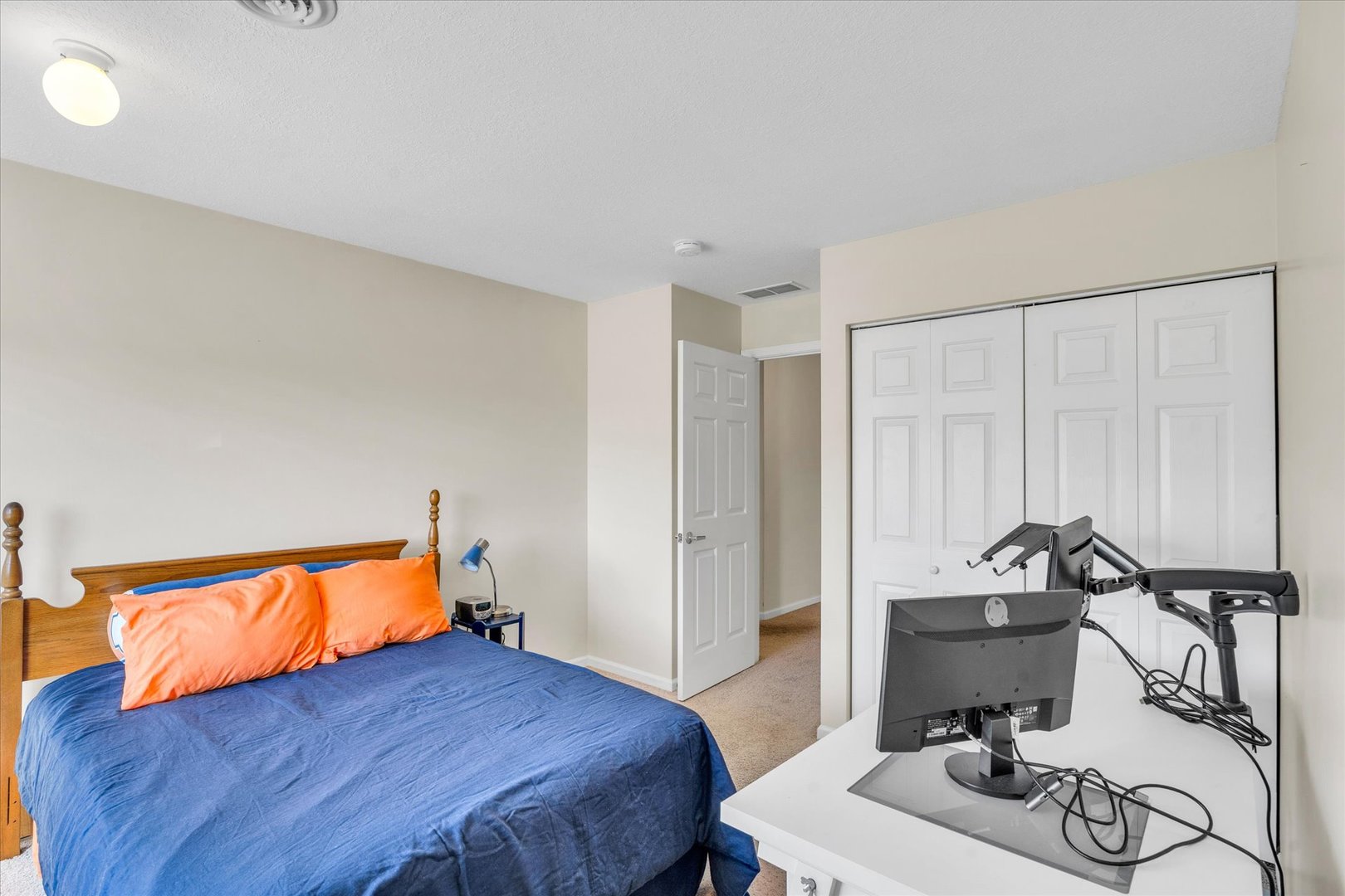 2402 Windward Boulevard, Unit 210 Champaign, IL 61821 - Photo 22 of 28 a bedroom with a bed and a table