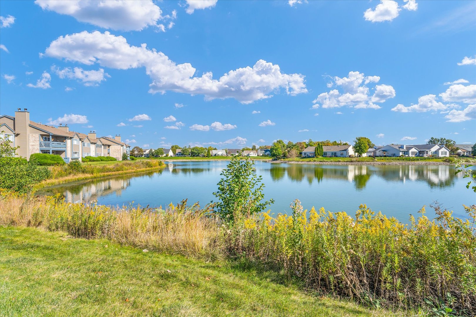 2402 Windward Boulevard, Unit 210 Champaign, IL 61821 - Photo 27 of 28 a view of a lake with outdoor space
