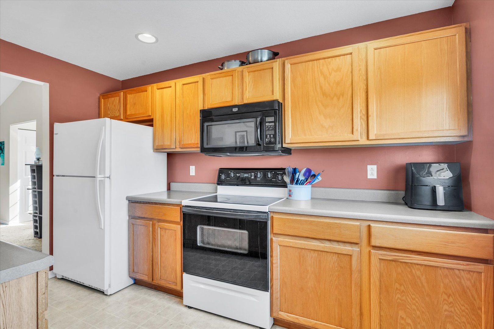 2402 Windward Boulevard, Unit 210 Champaign, IL 61821 - Photo 8 of 28 a kitchen with stainless steel appliances granite countertop a refrigerator a stove a sink and a microwave