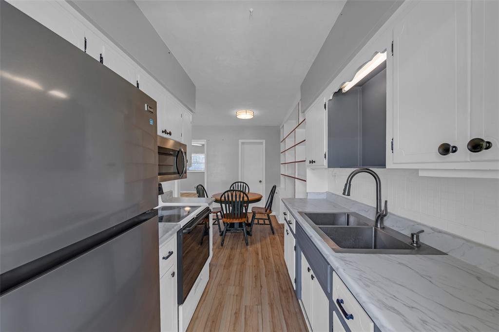 11 Southwest 4th Avenue, Unit 29 Boca Raton, FL 33432 - Photo 12 of 45 a kitchen with stainless steel appliances granite countertop a sink a stove top oven a counter space and cabinets