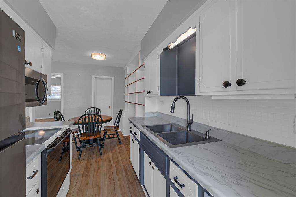 11 Southwest 4th Avenue, Unit 29 Boca Raton, FL 33432 - Photo 14 of 45 a kitchen with a sink cabinets and wooden floor