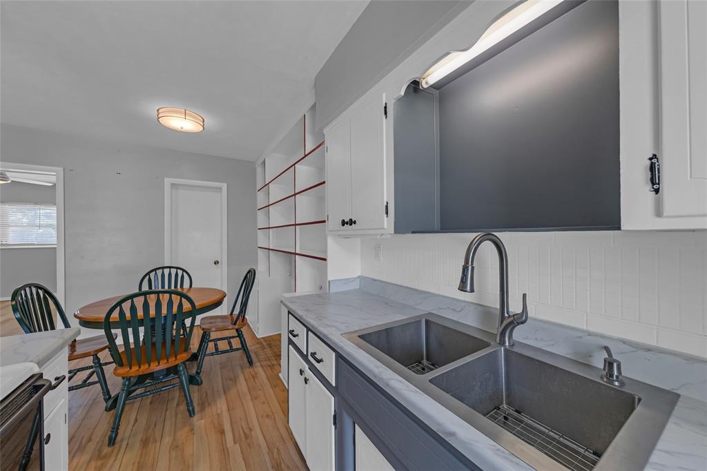 11 Southwest 4th Avenue, Unit 29 Boca Raton, FL 33432 - Photo 16 of 45 a kitchen with a table chairs sink and cabinets