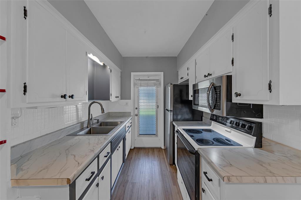 11 Southwest 4th Avenue, Unit 29 Boca Raton, FL 33432 - Photo 17 of 45 a kitchen with a sink stove and refrigerator