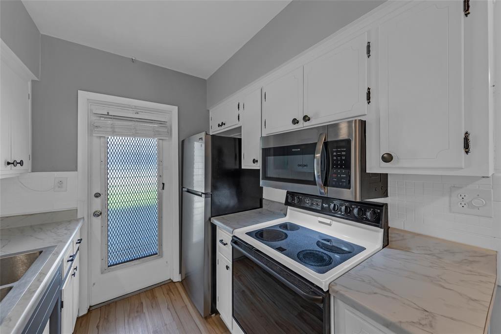 11 Southwest 4th Avenue, Unit 29 Boca Raton, FL 33432 - Photo 18 of 45 a kitchen with a stove and a microwave