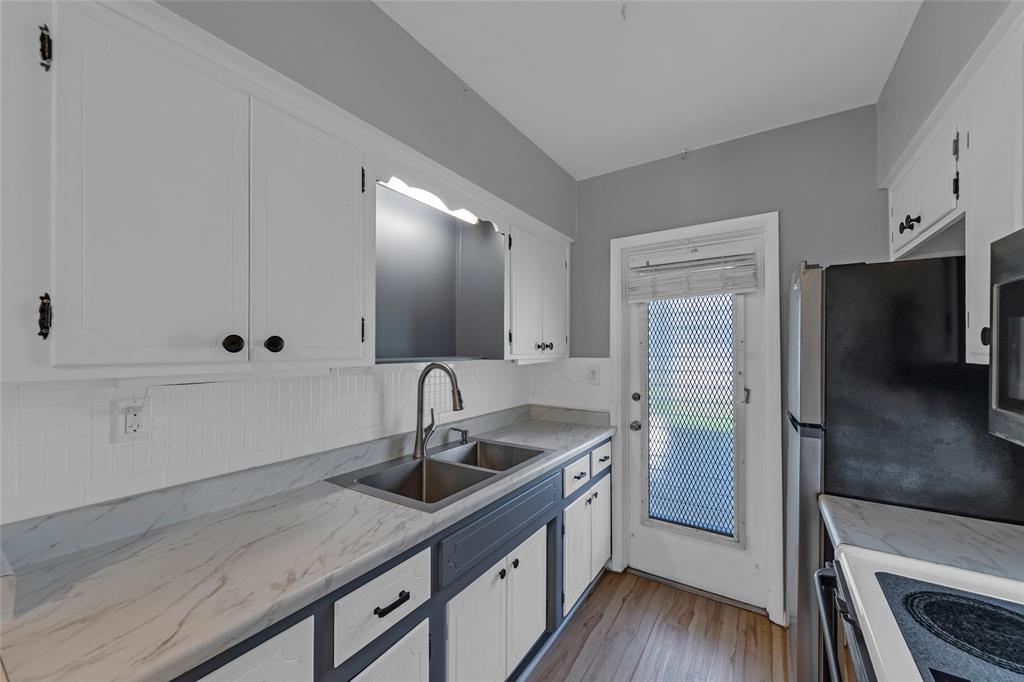 11 Southwest 4th Avenue, Unit 29 Boca Raton, FL 33432 - Photo 19 of 45 a kitchen with stainless steel appliances granite countertop a sink and a refrigerator