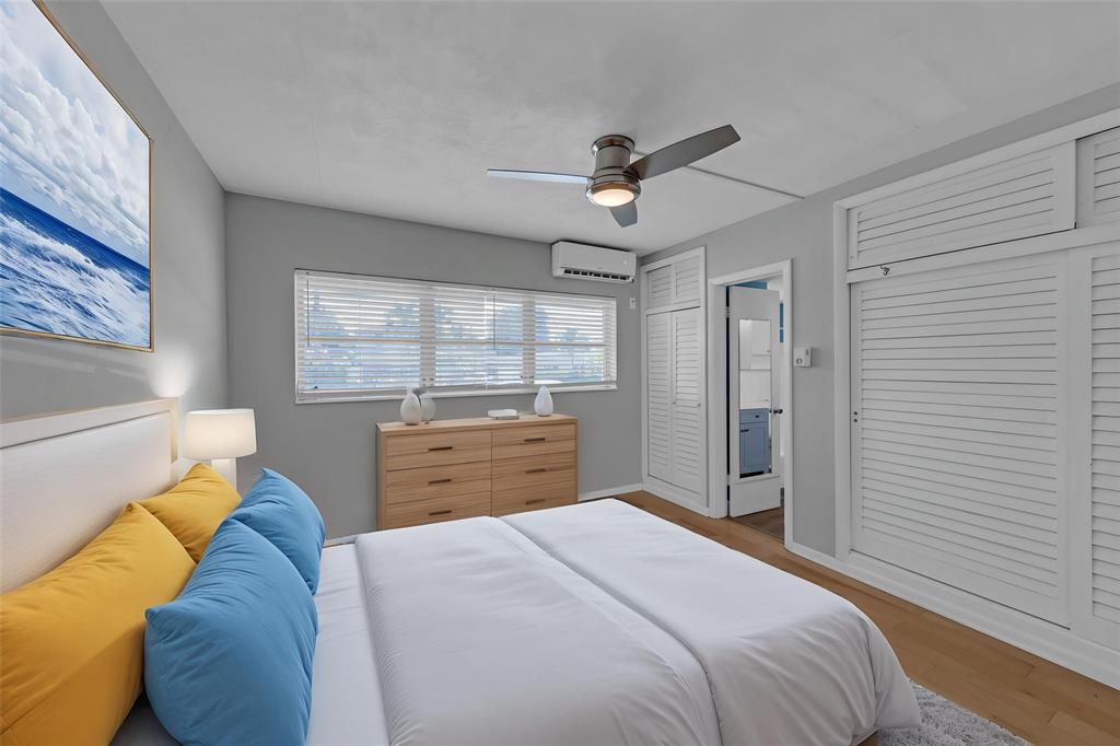 11 Southwest 4th Avenue, Unit 29 Boca Raton, FL 33432 - Photo 22 of 45 a bedroom with a bed dresser and a window