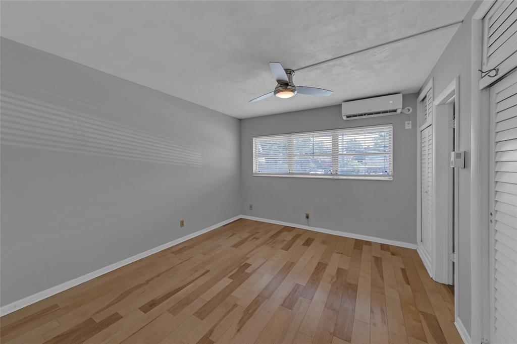 11 Southwest 4th Avenue, Unit 29 Boca Raton, FL 33432 - Photo 24 of 45 a view of empty room with wooden floor and fan