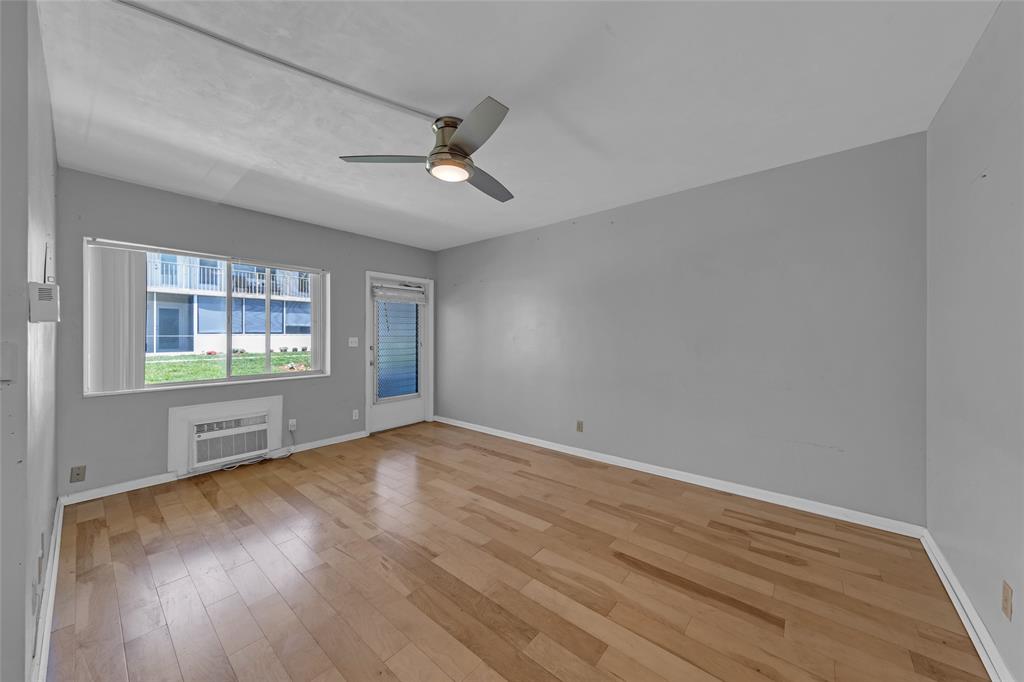 11 Southwest 4th Avenue, Unit 29 Boca Raton, FL 33432 - Photo 3 of 45 an empty room with wooden floor and windows