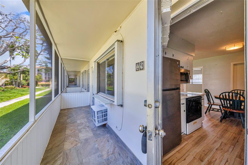 11 Southwest 4th Avenue, Unit 29 Boca Raton, FL 33432 - Photo 34 of 45 a view of a hallway view with living room and dining room