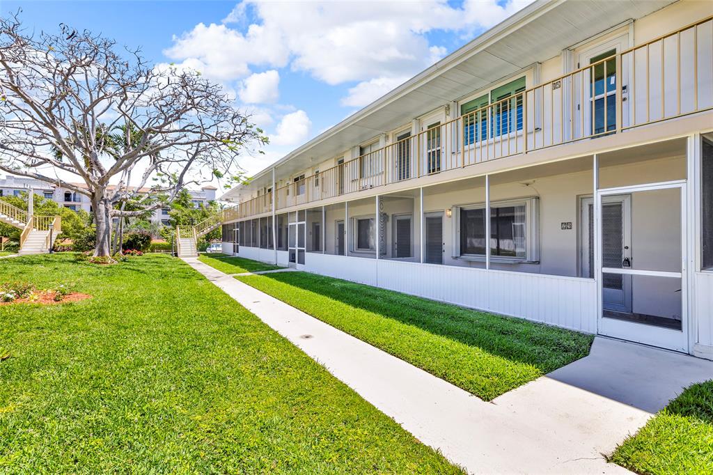 11 Southwest 4th Avenue, Unit 29 Boca Raton, FL 33432 - Photo 36 of 45 a view of house with a yard
