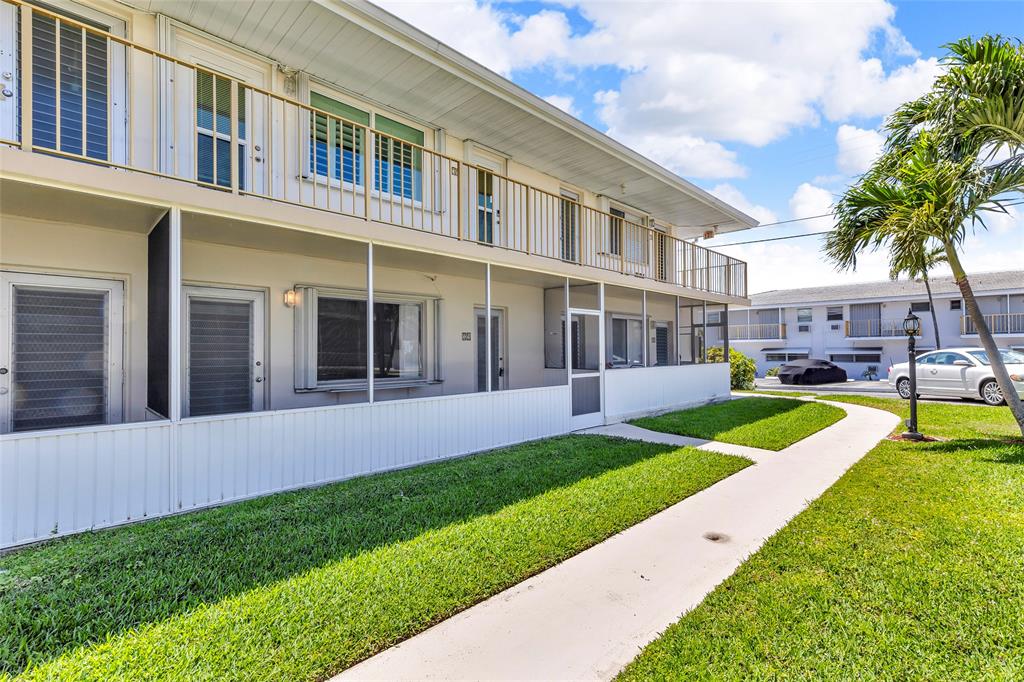 11 Southwest 4th Avenue, Unit 29 Boca Raton, FL 33432 - Photo 37 of 45 a view of a house with a yard and plants