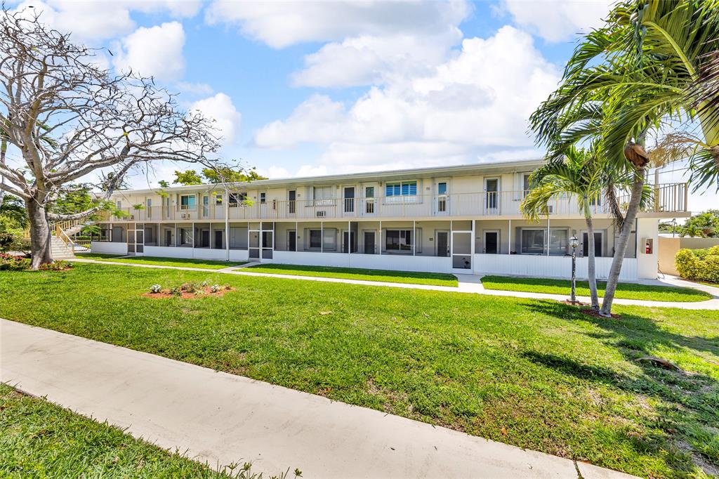 11 Southwest 4th Avenue, Unit 29 Boca Raton, FL 33432 - Photo 43 of 45 a view of a house with a swimming pool and a yard