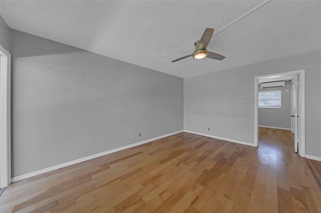 11 Southwest 4th Avenue, Unit 29 Boca Raton, FL 33432 - Photo 5 of 45 wooden floor in an empty room with a window