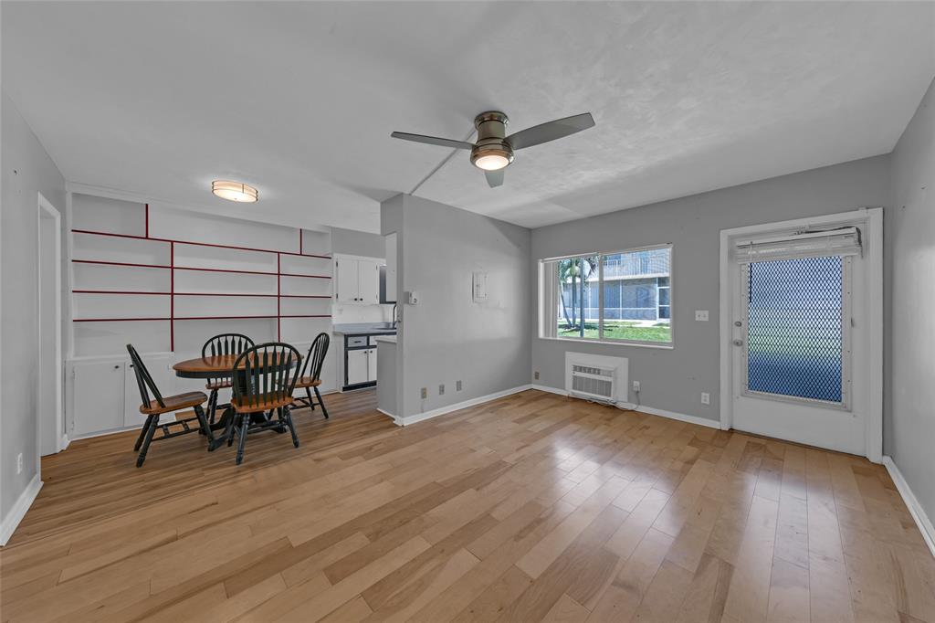 11 Southwest 4th Avenue, Unit 29 Boca Raton, FL 33432 - Photo 6 of 45 a view of a dining room with furniture and wooden floor
