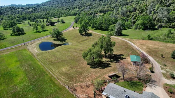 an aerial view of a house with yard swimming pool and outdoor seating