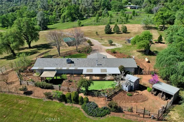 a front view of a house with garden and patio
