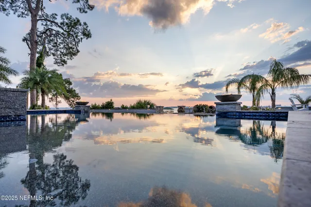 a front view of a house with swimming pool and sitting area