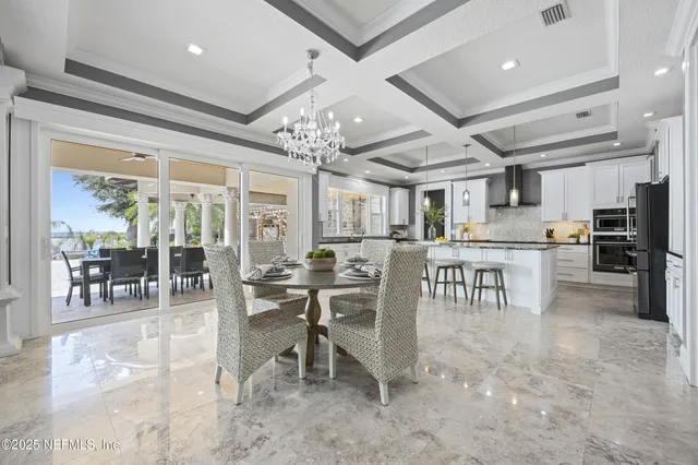 a view of a patio with table and chairs and potted plants
