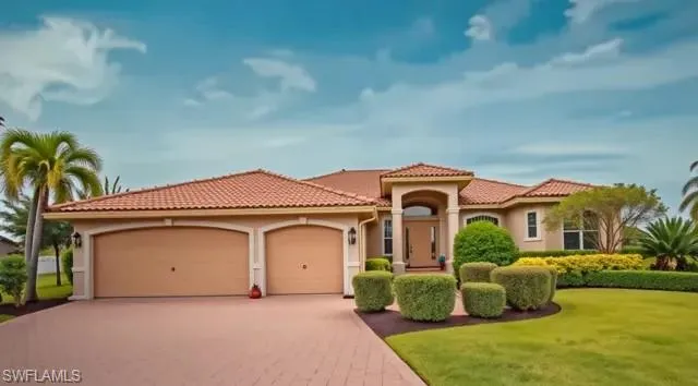 a front view of a house with a yard and garage