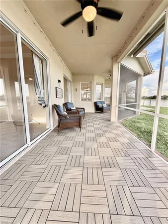 a living room with furniture and a floor to ceiling window