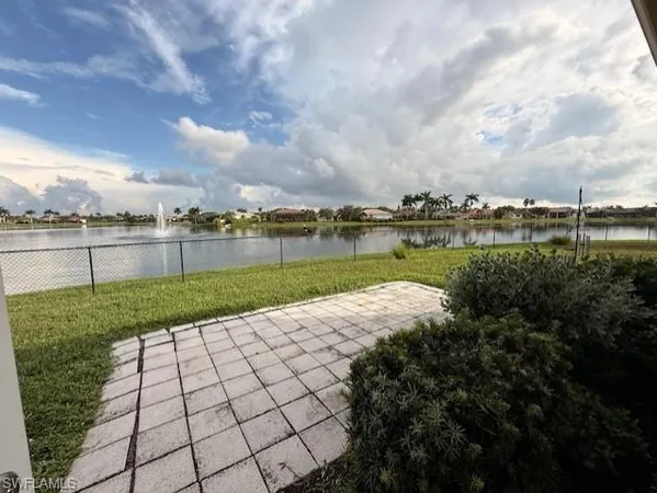 a view of a house with a big yard and large tree
