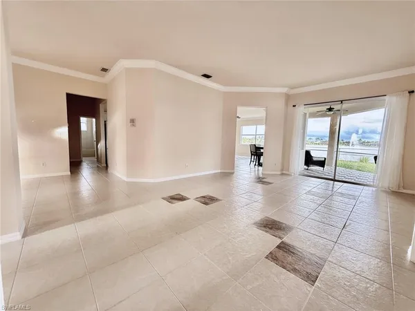 a view of a hallway with wooden floor and a living room