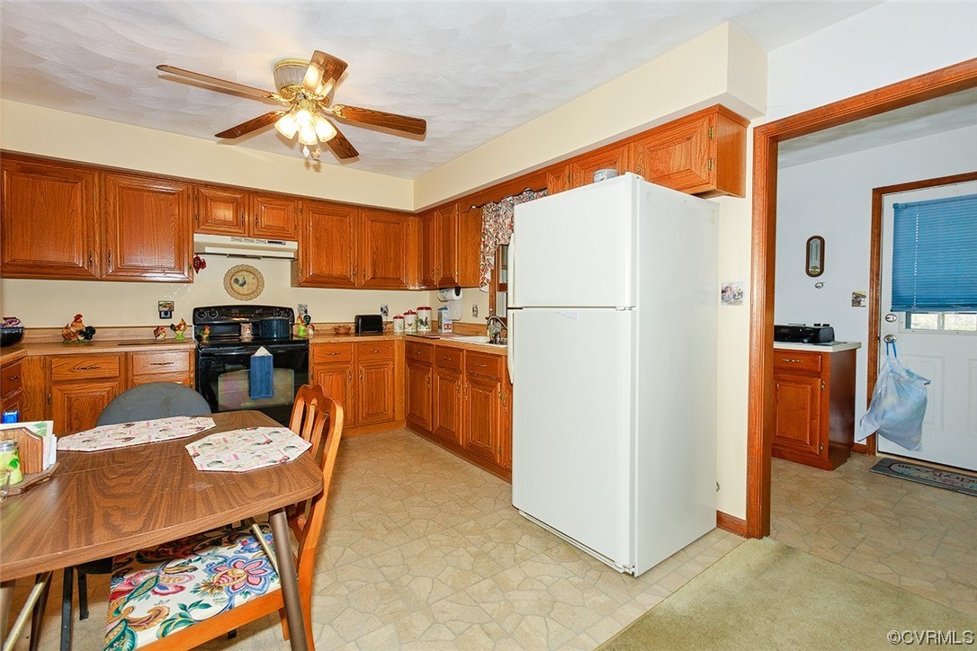 619 Spring Grove Road Spring Grove, VA 23881 - Photo 5 of 45 a kitchen with stainless steel appliances granite countertop a refrigerator a stove a sink a dining table and chairs