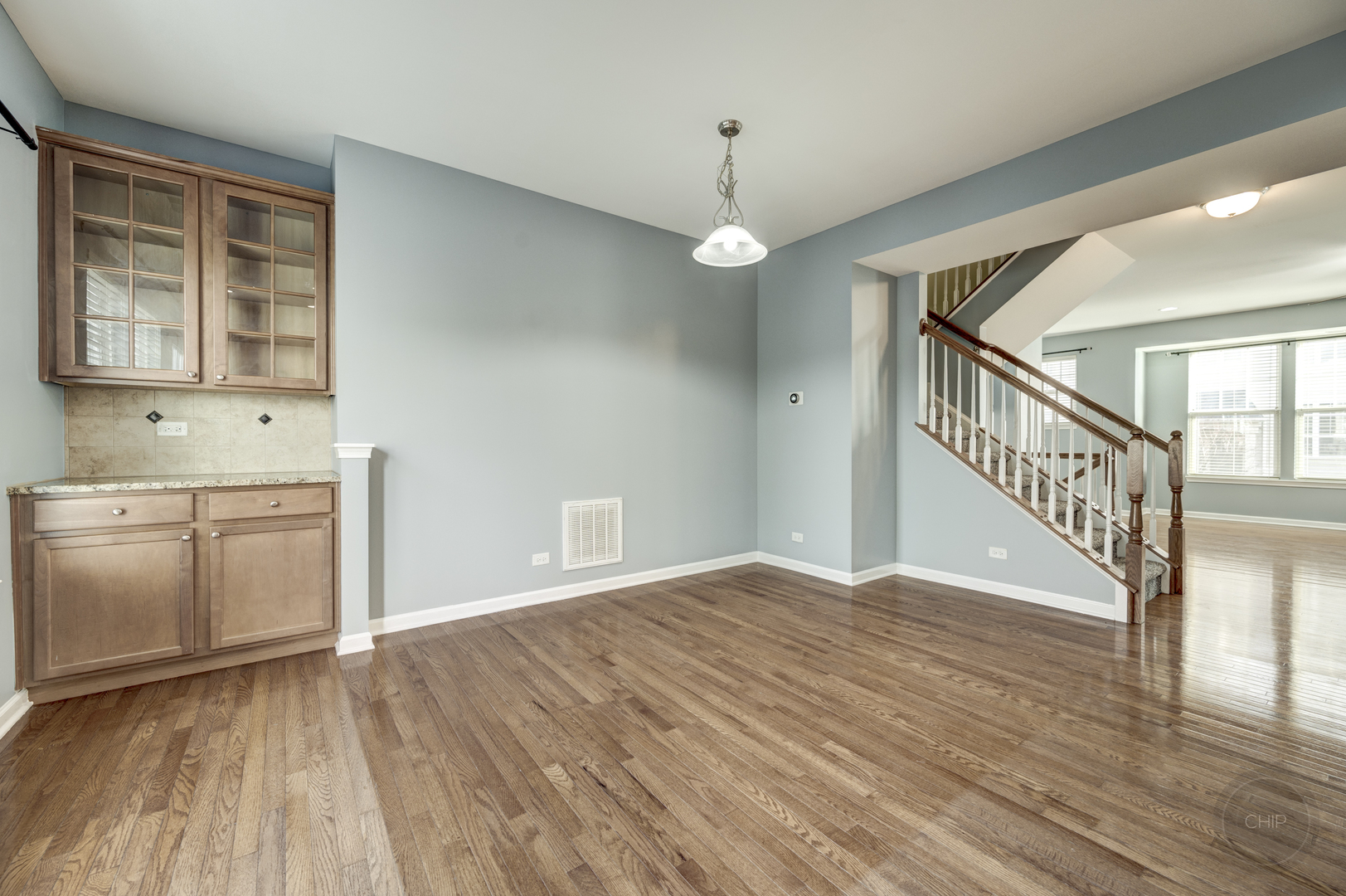 331 North Commerce Street Aurora, IL 60504 - Photo 12 of 41 a view of an empty room with a window and wooden floor