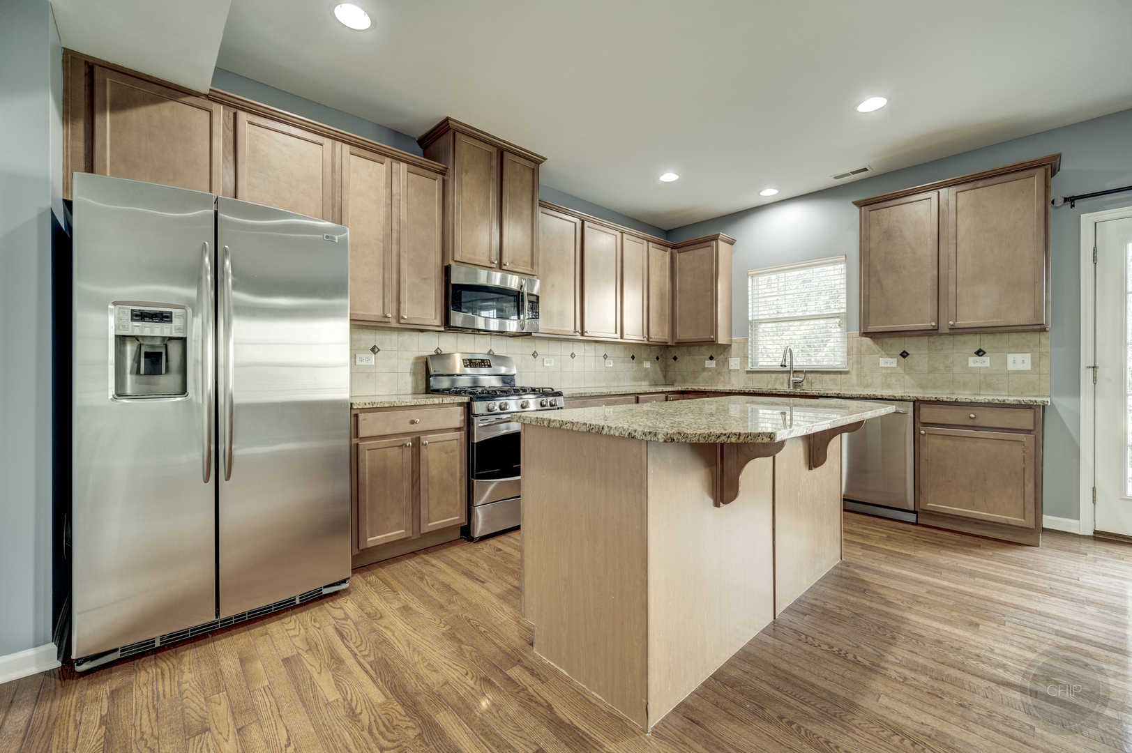 331 North Commerce Street Aurora, IL 60504 - Photo 16 of 41 a kitchen with stainless steel appliances granite countertop a refrigerator a sink dishwasher a stove and white countertops with wooden floor