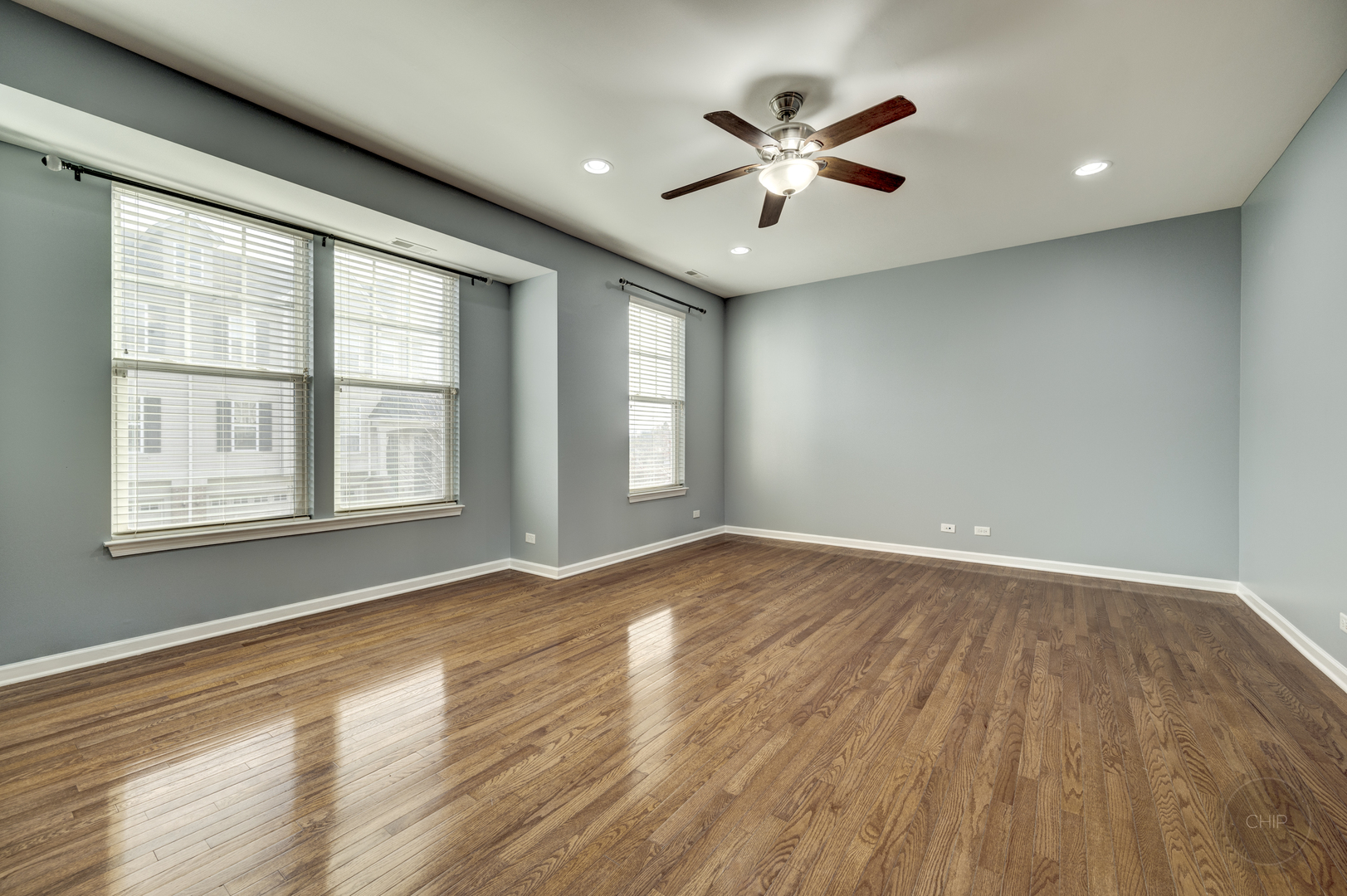 331 North Commerce Street Aurora, IL 60504 - Photo 2 of 41 an empty room with wooden floor and windows