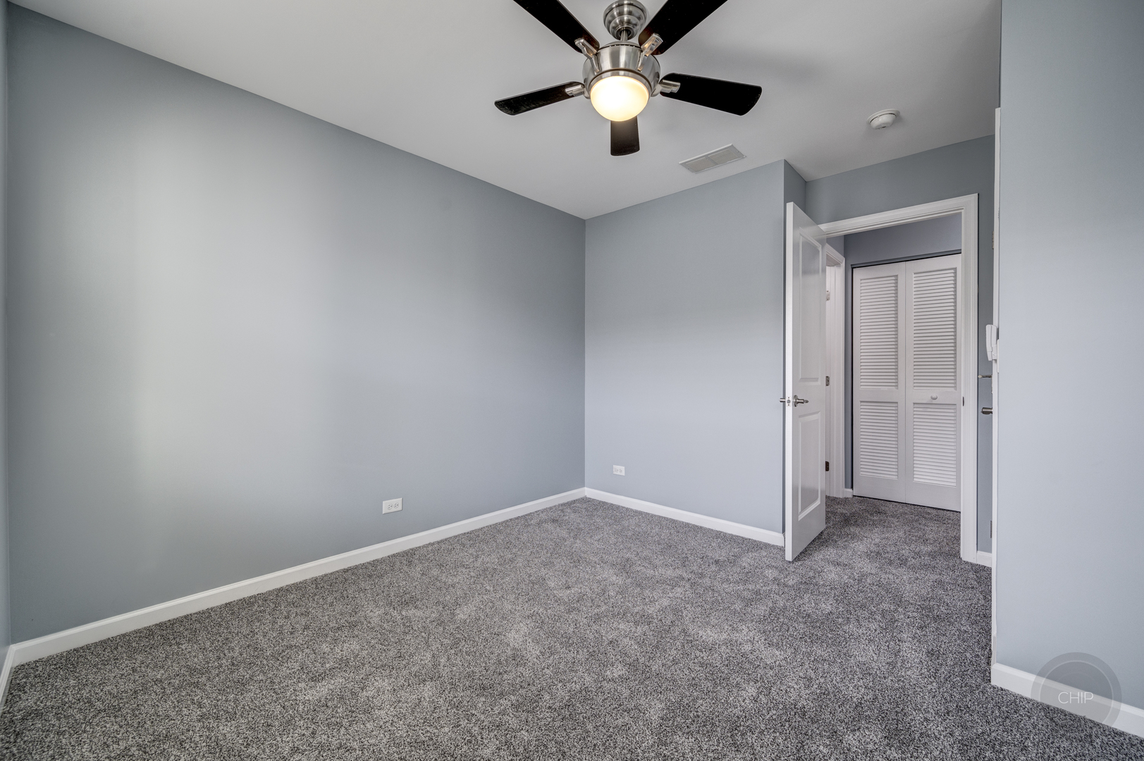 331 North Commerce Street Aurora, IL 60504 - Photo 24 of 41 an empty room with a chandelier fan and windows