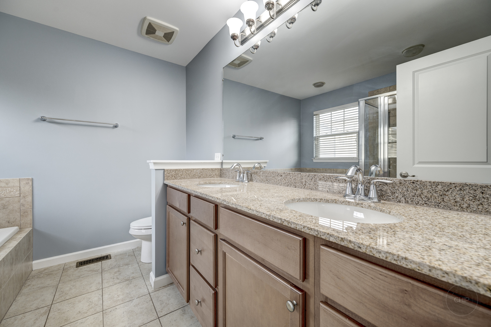 331 North Commerce Street Aurora, IL 60504 - Photo 31 of 41 a bathroom with a granite countertop sink a toilet and a mirror