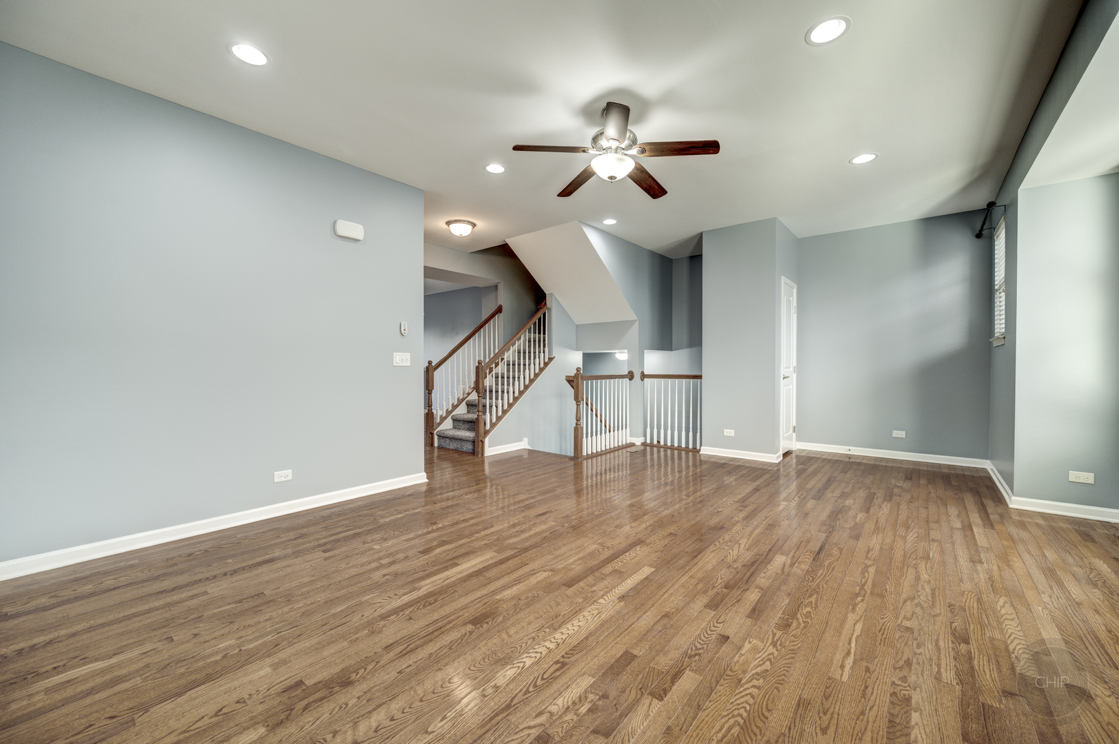 331 North Commerce Street Aurora, IL 60504 - Photo 4 of 41 a view of an empty room with wooden floor ceiling fan