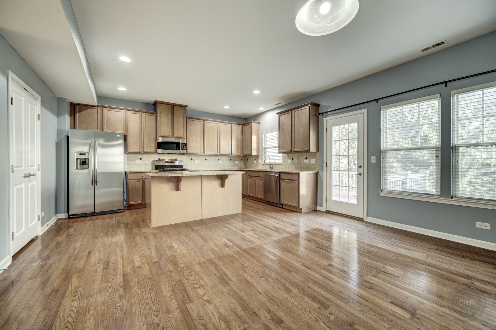 331 North Commerce Street Aurora, IL 60504 - Photo 9 of 41 a kitchen with stainless steel appliances granite countertop a stove a sink dishwasher a refrigerator white cabinets and wooden floor