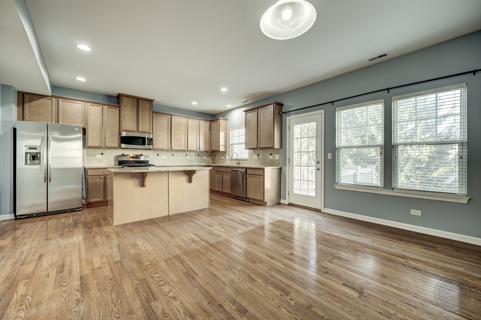 331 North Commerce Street Aurora, IL 60504 - Photo 10 of 41 a kitchen with stainless steel appliances granite countertop a stove a sink dishwasher a refrigerator and a microwave oven with wooden floor