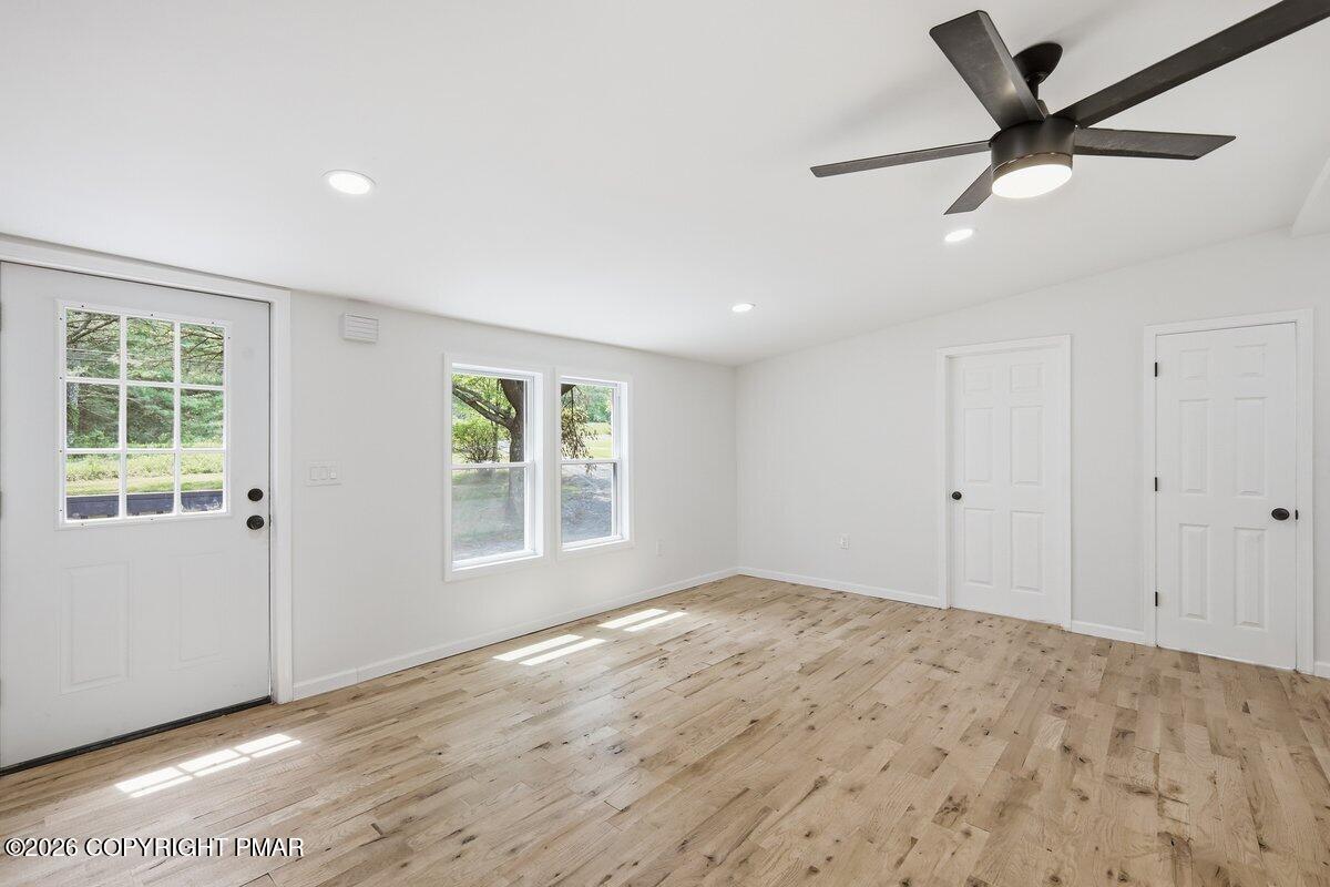 155 Blooming Grove Road Hawley, PA 18428 - Photo 30 of 41 a view of a livingroom with a window and a ceiling fan