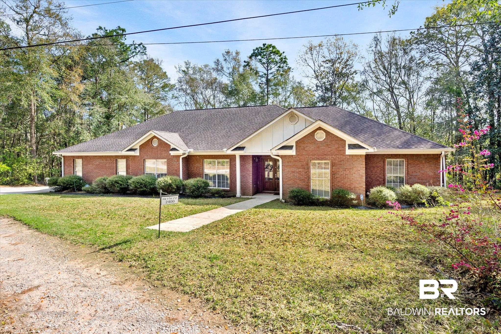 2400 Waterford Road Semmes, AL 36575 - Photo 1 of 30 View of front of property featuring brick siding, a front lawn, a shingled roof, and board and batten siding