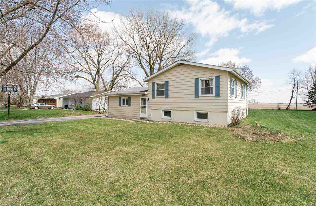 6775 South Sarah Avenue Rochelle, IL 61068 - Photo 1 of 26 a view of a yard in front of a house with large trees