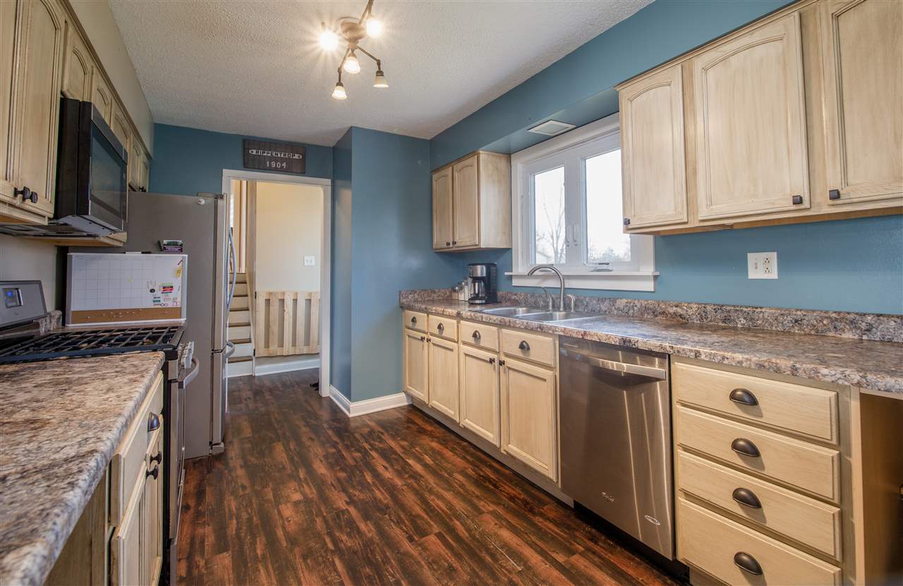 6775 South Sarah Avenue Rochelle, IL 61068 - Photo 13 of 26 a kitchen with stainless steel appliances granite countertop a stove a sink dishwasher and a refrigerator with wooden floor